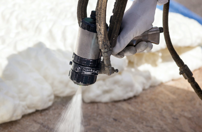 contractor spraying foam with tool in milwaukee